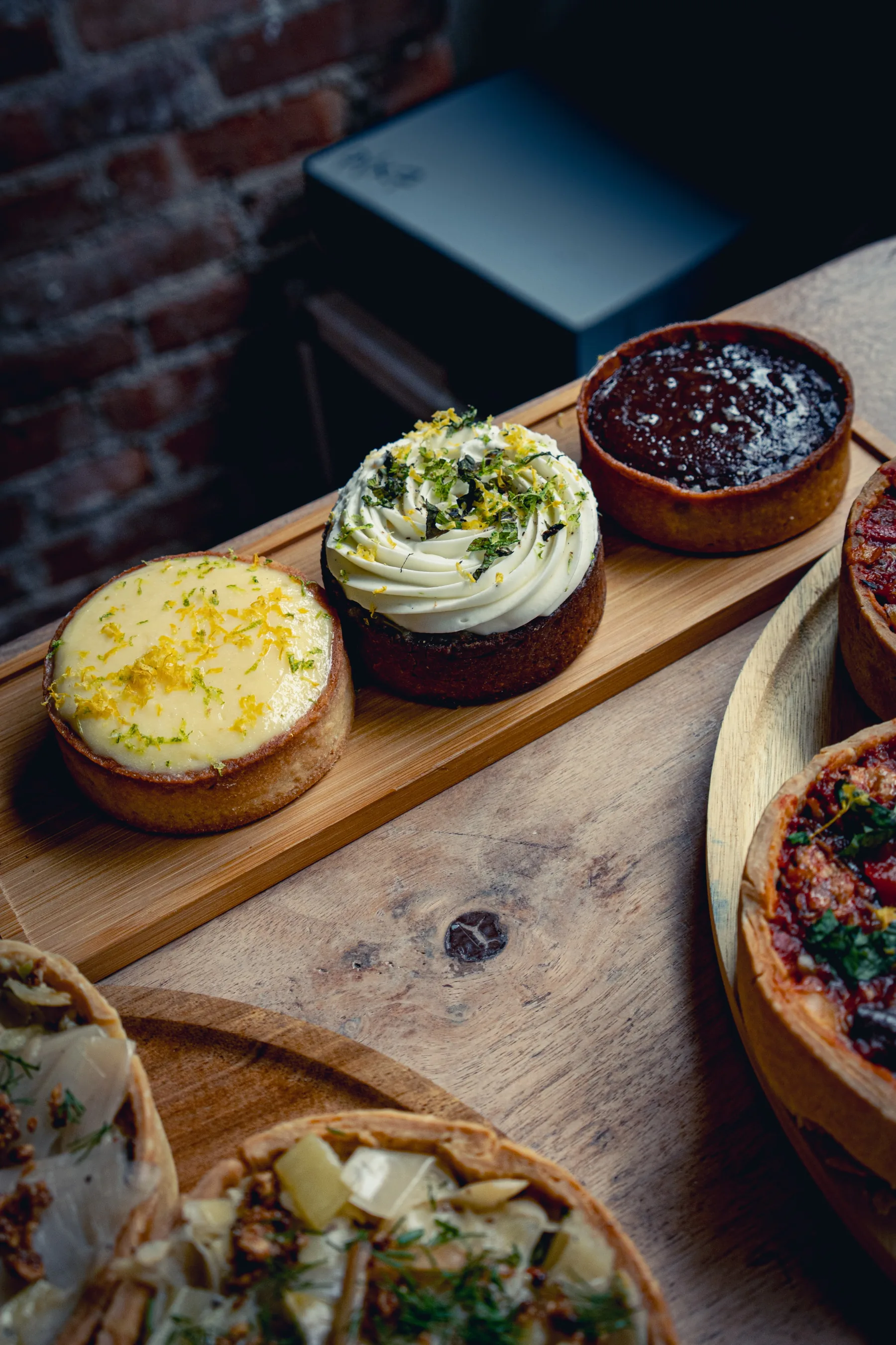 A close-up assortment of La Méchante savory and sweet tartes