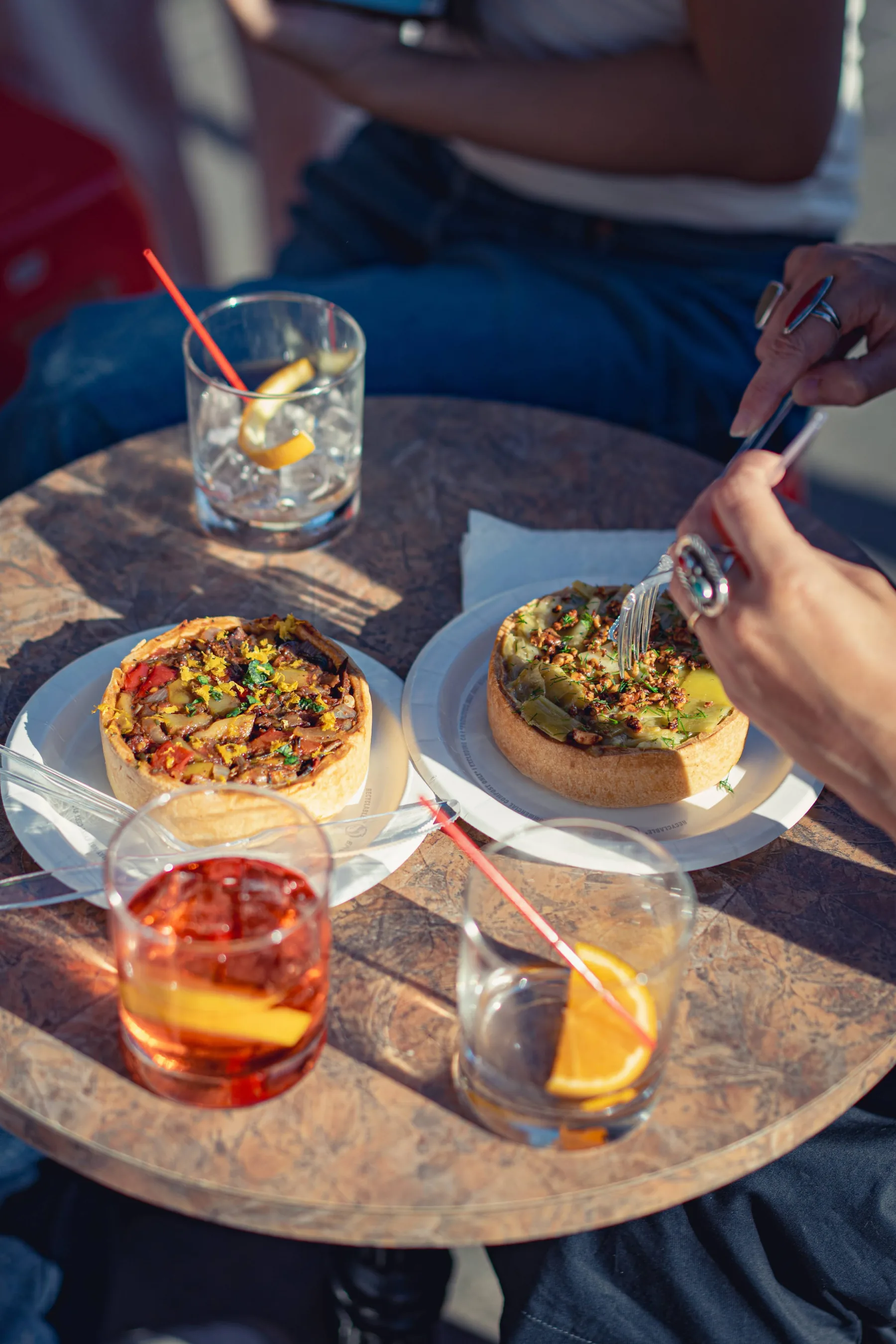 Friends sharing La Méchante tartes around a table