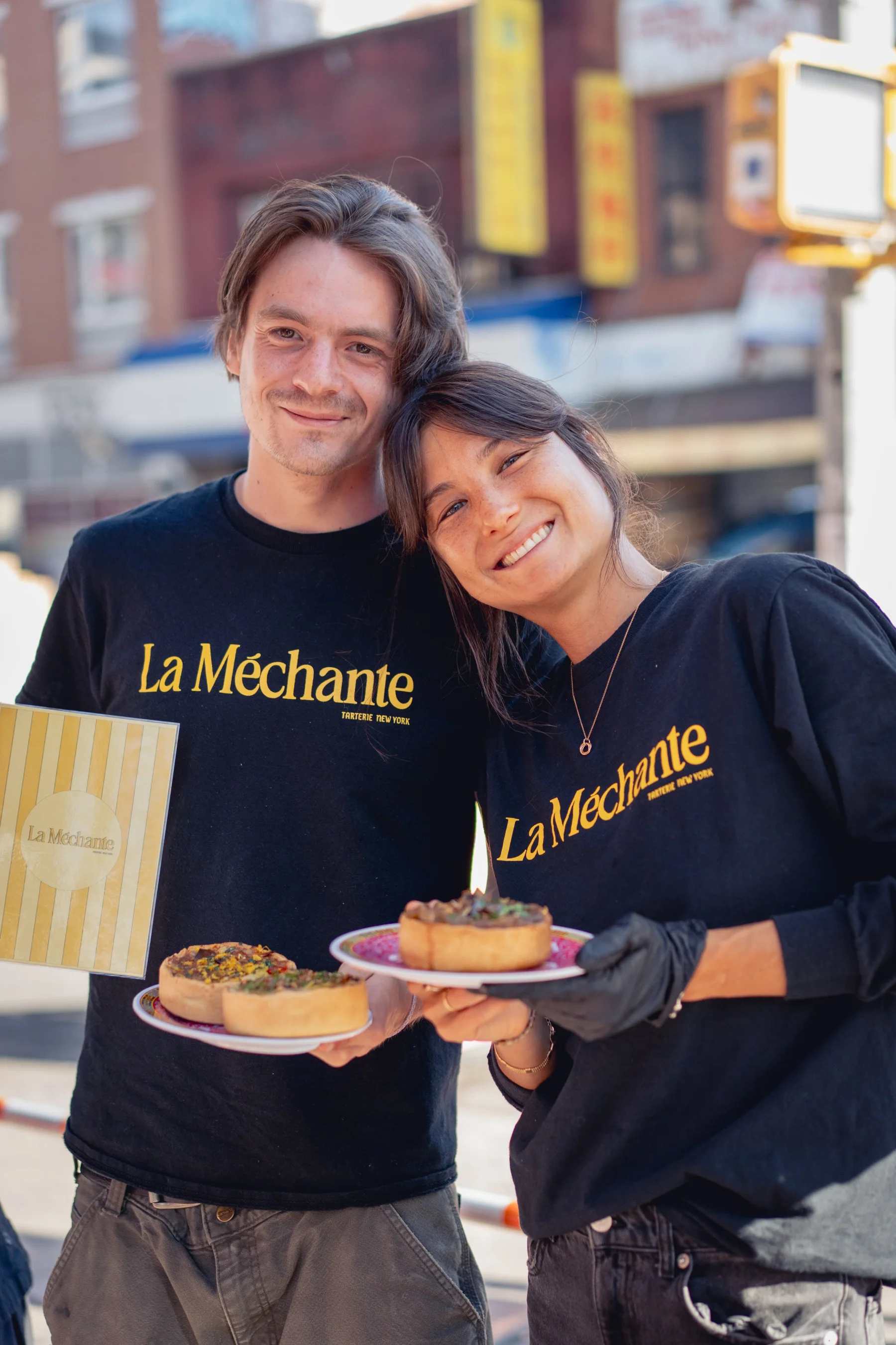 Two members of La Méchante serving tartes together in New York